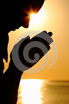 Silhouette of woman prays