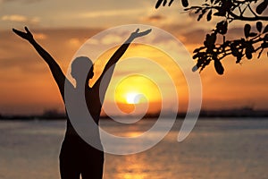 Silhouette woman raise hands feeling relax and freedom. People running and workout in sunset background.