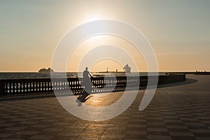 Silhouette of Woman Riding Bicycle on Livorno& x27; s Mascagni Terrac