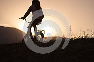 Silhouette of woman riding a bike