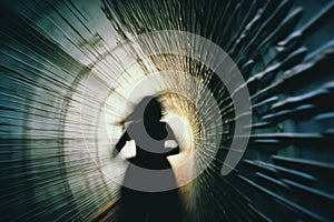 A silhouette of a woman running, fleeing from something, through a tunnel. View from behind. AI generated