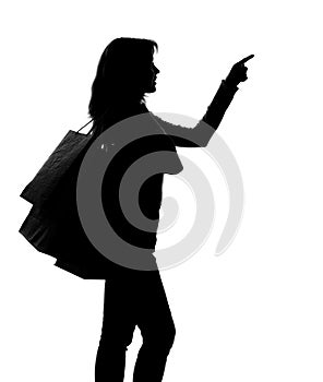 Silhouette of a woman with shopping bags