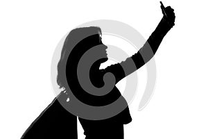 Silhouette of a woman with shopping bags doing selfie