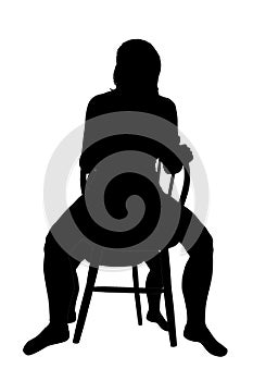 Silhouette of a woman sitting on a chair