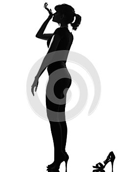 Silhouette woman smelling perfume