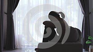 Silhouette of Woman suffering from depression lies on the sofa , has stress, anxiety, sickness and headaches, life problems,