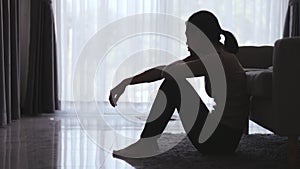 Silhouette of Woman suffering from depression lies on the sofa , has stress, anxiety, sickness and headaches, life problems,