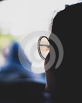 Silhouette of a woman in sunglasses with copy space and bokeh background