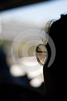 Silhouette of a woman in sunglasses with copy space and bokeh background