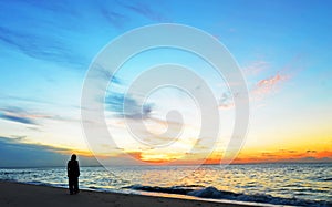 Silhouette woman,sunset on ocean Amity Point beach, North Stradbroke Island,Australia