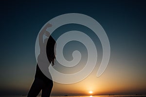 silhouette of a woman at sunset at sea rest beach walk travel