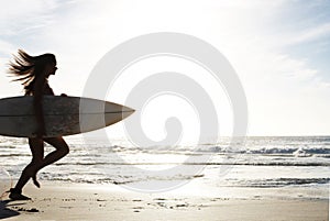 Silhouette, woman surfer run on beach sand and sea, exercise outdoor with surfboard to surf in nature. Sport, shadow and