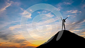 Silhouette woman on top hill in sunet photo
