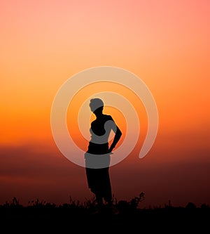 Silhouette woman walking and beautiful twilight ight background on the street.