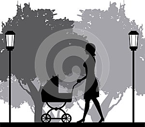 Silhouette woman walking with pram baby in park