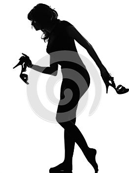 Silhouette woman walking quite barefoot on tiptoe