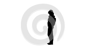Silhouette of a woman walking in the street. Side view . White background