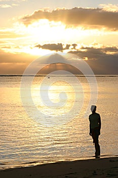 Silhouette of Woman watching the sunset photo