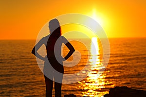 Silhouette of a woman watching sunset