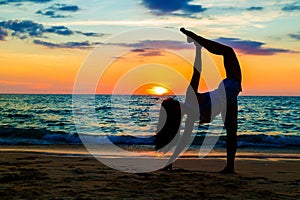 Silhouette woman with yoga posture on the sea beach