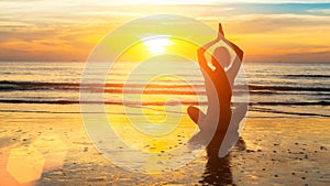 Silhouette woman yoga on the sea beach