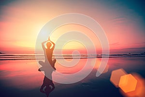 Silhouette of a woman yoga on sea sunset. Relax.