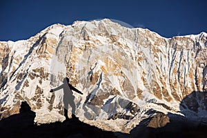 Silhouette women backpacker on the rock and Annapurna I Background 8,091m from Annapurna Basecamp ,Nepal.