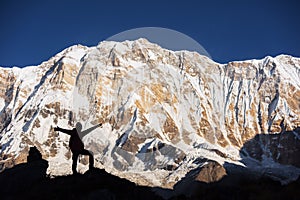 Silhouette women backpacker on the rock and Annapurna I Background 8,091m from Annapurna Basecamp ,Nepal.