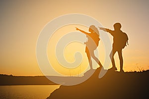 Silhouette women and girl backpacker on the top mountain