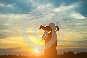 Silhouette women Nature photographer with digital camera on the mountain and lake