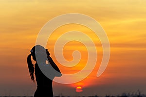 Silhouette women runner listening music and feeling freedom, happy and enjoying nature sunse