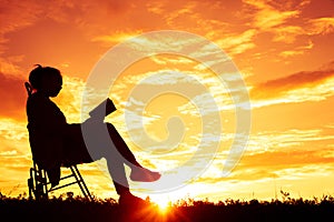 Silhouette women sitting read a book on holiday.