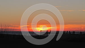 Silhouette of a wooden fence at sunset