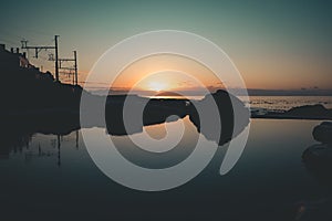 Silhouette of the Woolleys Tidal public Pool at sunset in South Africa