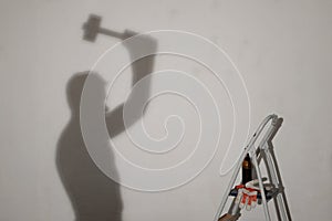 Silhouette of a worker with the hammer