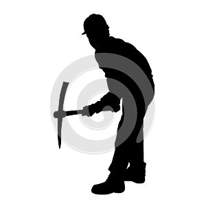 silhouette of a worker swinging his mattock tool.