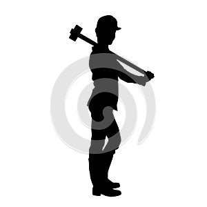 silhouette of a worker swinging his sledge hammer.