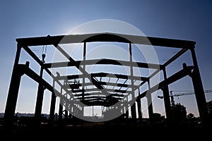 Silhouette of the workers dissembling industrial warehouse 2