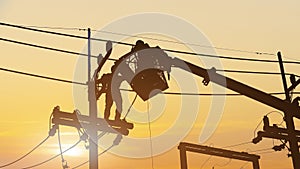 Silhouette Electricians work on high voltage