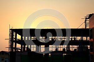 silhouette workers working in construction site at sunset