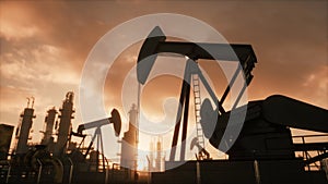 Silhouette of working oil pump jack at sunset. The oil pump, industrial equipment