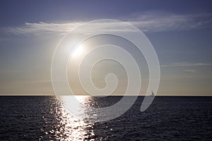 Silhouette of a yacht in the Black sea at dawn, quiet and calm, background