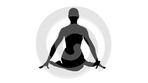 Silhouette Yoga girl practicing nadi shodhana pranayama or Breathingin in gomukhasana asana or cow head pose.