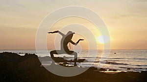 Silhouette yoga practice at sunset. Yong woman doing yoga exercise on the beach