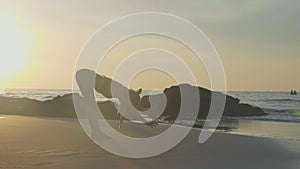 Silhouette yoga practice at sunset. Yong woman doing yoga exercise on the beach