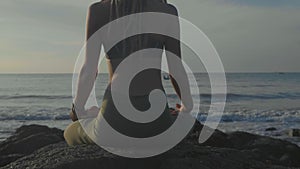 Silhouette yoga practice at sunset. Yong woman doing yoga exercise on the beach