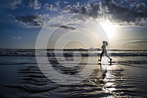 Silhouette of young Asian sport runner woman in running workout