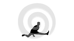 Silhouette Young attractive male dancer in the strict business suit dancing making a split.