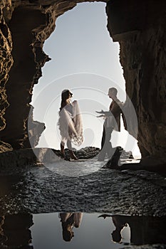 Silhouette of young beautiful bridal couple having fun together at the beach