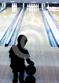 Silhouette of young boy in bowling